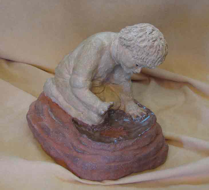 Boy Imprinting Hand in Mud